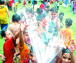 Schoolchildren enjoy a splash at a summer camp in Amritsar