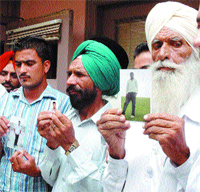 Relatives show photographs of their kin facing death in the UAE
