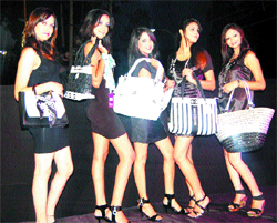 Models display outfits during a fassion show organised on occassion of inauguration of two showrooms 