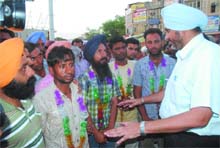 SDM Bathinda KPS Mahi talking to members of unemployed linemen union after they climbed down from the overhead water tank on Tuesday evening. 