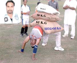 Naik Harjinder Singh in action with three weights of 141 kg on his arched body during a performance of Chakrasana. Inset (Naik Harjinder Singh).
