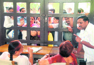 Parents wait outside a prospectus-sale counter at one the schools in Chandigarh on Tuesday.