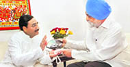 Uttarakhand Chief Minister Ramesh Pokhriyal Nishank interacts with Deputy Chairman of the Planning Commission Montek Singh Ahluwalia in New Delhi 