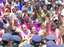 Members of the Mohalla Swachhta Samiti protest near the Secretariat in Dehradun on Tuesday