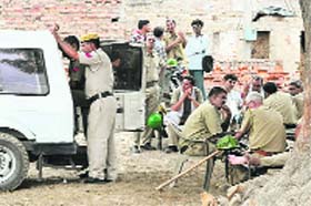 Policemen stand guard in the Surya Nagar locality of Hisar