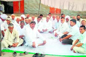 Members of the Kandela Khap on a dharna outside the mini-secretariat at Jind