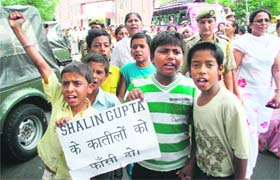 Residents of Nai Basti protest against the killing of Shalin Gupta at Gandhi Nagar in Jammu