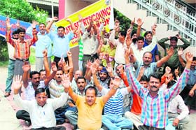 Members of the J&K Sports Council Employees Union protest in support of their demands in Jammu