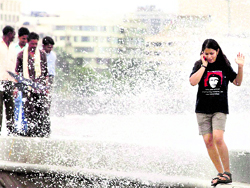 People enjoy a high tide in Mumbai on Tuesday