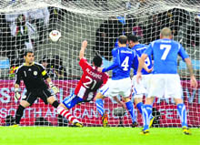 Paraguays defender Antolin Alcaraz scores the opening goal during their match against Italy in Cape Town on Monday. 
