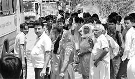 Passengers stranded near Azad Colony, Sector 21, Panchkula, on Wednesday
