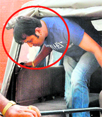 Financier Nitin, the main accused, comes out of a police Gypsy at the Mansa Devi Complex police station.