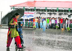 Some take shelter, others take to umbrellas