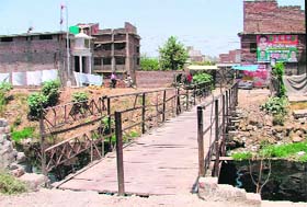 The proposed site for the new bridge parallel to an existing wooden one at Haibowal
