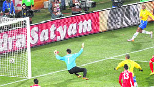 Brazils Maicon (R) sends the ball past North Koreas goalkeeper Ri Myong-Guk to score Brazils first goal in Johannesburg on Tuesday.