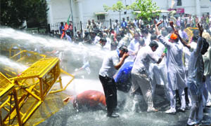 Delhi police personnel use water cannons to disperse BJP activists participating in a demonstration in New Delhi on Friday. The activists were protesting against the rise in CNG prices .