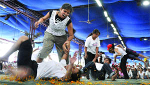 Girls learn self defence techniques at a self defence camp organised by the Delhi police in New Delhi on Friday.