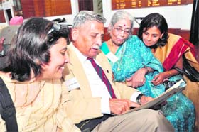 Ex-serviceman CN Satyamurthy, a 1960 batch pass-out, shows his record file as cadet to his family members at a reunion of the IMA in Dehradun