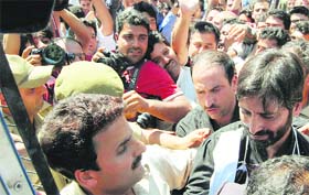 Chairman of the Jammu and Kashmir Liberation Front Yasin Malik along with his supporters courts arrest at Lal Chowk in Srinagar
