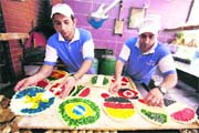 Bakers in Beirut prepare local pastries called manakish decorated with the designs and flag colours representing the countries competing in this year's FIFA World Cup
