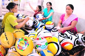 Women workers busy washing footballs at the sports goods unit