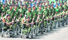 Disabled army soldiers take part in the parade during a war victory ceremony in Colombo
