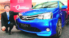 Toyota Kirloskar Motors MD Hiroshi Nakagawa poses with the Etios concept car during its launch in Kolkata on Saturday.