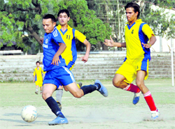A match in progress during the District Football League in Dehradun on Saturday