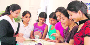 Students look at prospectuses to take admission to different courses at the Khalsa College in Ludhiana on Saturday.