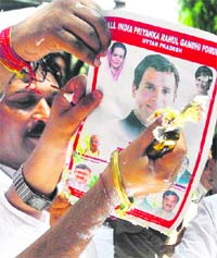Congress supporters offer cake to a Rahul Gandhis poster on his 40th birthday in New Delhi on Saturday.