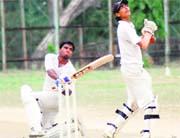 A batsman sweeps as the wicketkeeper looks on in a match during the Challenger Cup cricket tournament in Dehradun on Sunday.