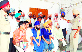 A policeman educates a group of drivers about hazards of traffic violations in 
