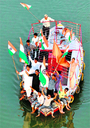 Students of Allahabad University hold a protest demanding hoisting of the National Flag at the new Yamuna bridge in Allahabad on Sunday