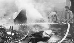 A firefighter douses a blaze at a junk shop in the Industrial Area, Mohali