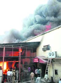 Firemen try to douse flames at Bata godown in Faridabad
