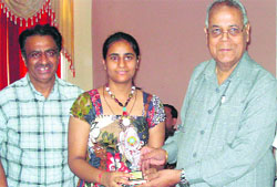 Rattan Chand Jain, chairman of the management committee of PKR Jain Public School, Ambala City, honours a meritorious student