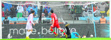 North Koreas goalkeeper Ri Myong-Guk (R) misses a goal by Portugal's midfielder Tiago (C)