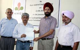 Officials of the Guru Gobind Singh Refinery presenting a cheque to Bathinda DC Gurkirat Kirpal Singh