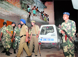Security personnel outside Shalimar hotel in Burail village on Tuesday
