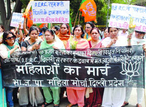 Women activists of the Delhi unit of Bharatiya Janata Party hold a demonstration against the Delhi government for allegedly forcing the Delhi State Regulatory Commission to hike power tariff in New Delhi on Tuesday.