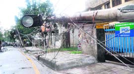 A view of uprooted electric poles after a dust storm and heavy rain on the Rajpur Road in Dehradun on Tuesday.