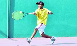 A young tennis player in action in the All-India Tennis Tournament played in Dehradun on Monday.