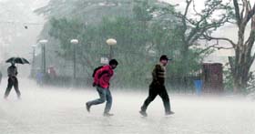 People running for shelter in sudden rain which lashed Shimla on Tuesday.
