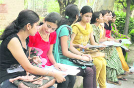 Students fill admission forms at Government College For Women at Gandhi Nagar in Jammu