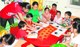 Tiny tots learn art and craft work at a camp in a Jammu school.
