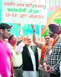 BJP leaders Navjot Singh Sidhu, Manoranjan Kalia and Balbir Punj release a party banner in Jalandhar