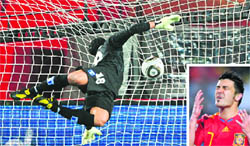 Honduras goalkeeper Noel Valladares misses a goal from Spains striker David Villa; and (inset) Villa reacts after missing a penalty kick during their match in Johannesburg