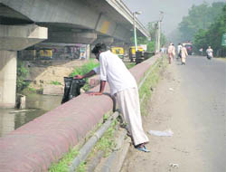 A commuter dumps plastic bag in the Sirhind canal on the Doraha bridge.