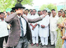 An artiste enacts the role of former chairman of Union Carbide, Warren Anderson, during a street play on gas tragedy, in Bhopal 