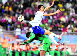 South Koreas Kim Jung-Woo flies over the top of Nigerias Nwankwo Kanu (bottom) during their match in Durban on Tuesday
